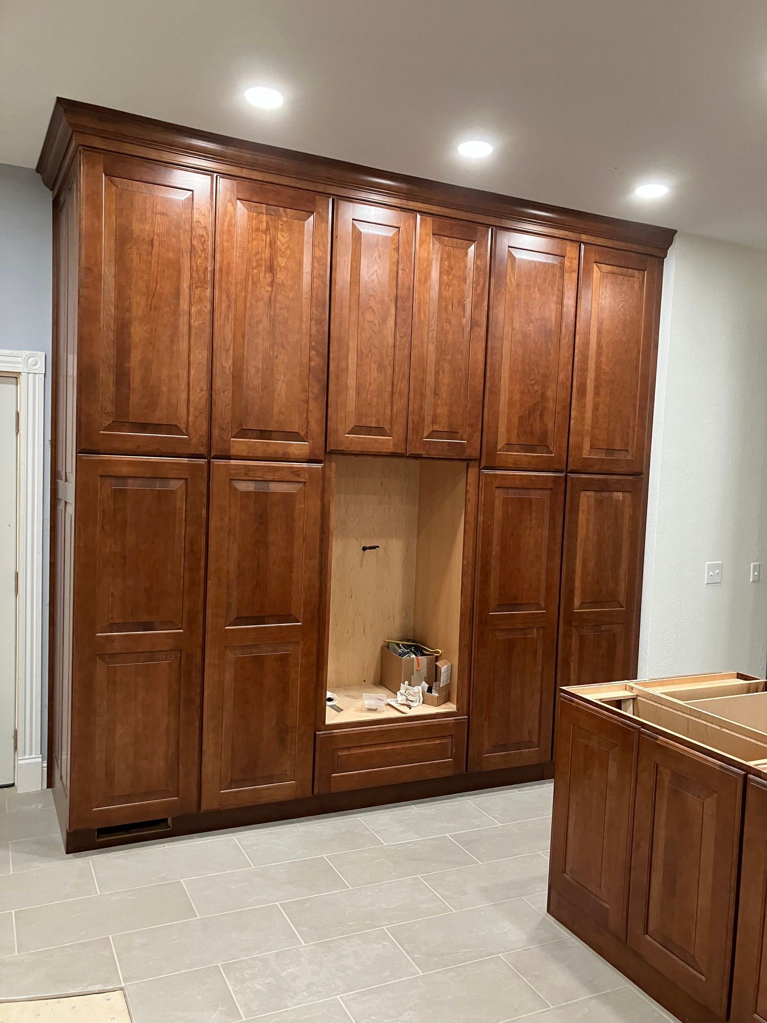 A kitchen with a lot of wooden cabinets and drawers