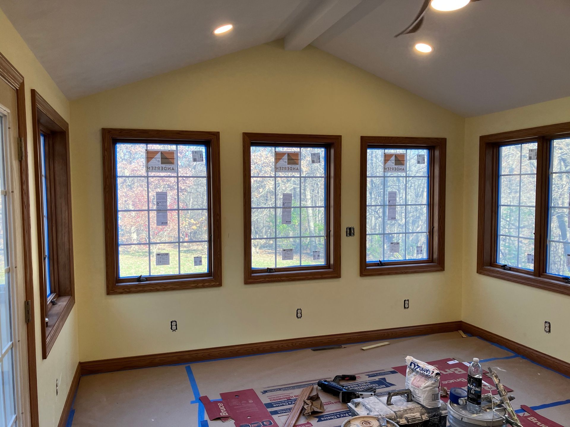 A room with a lot of windows and a vaulted ceiling