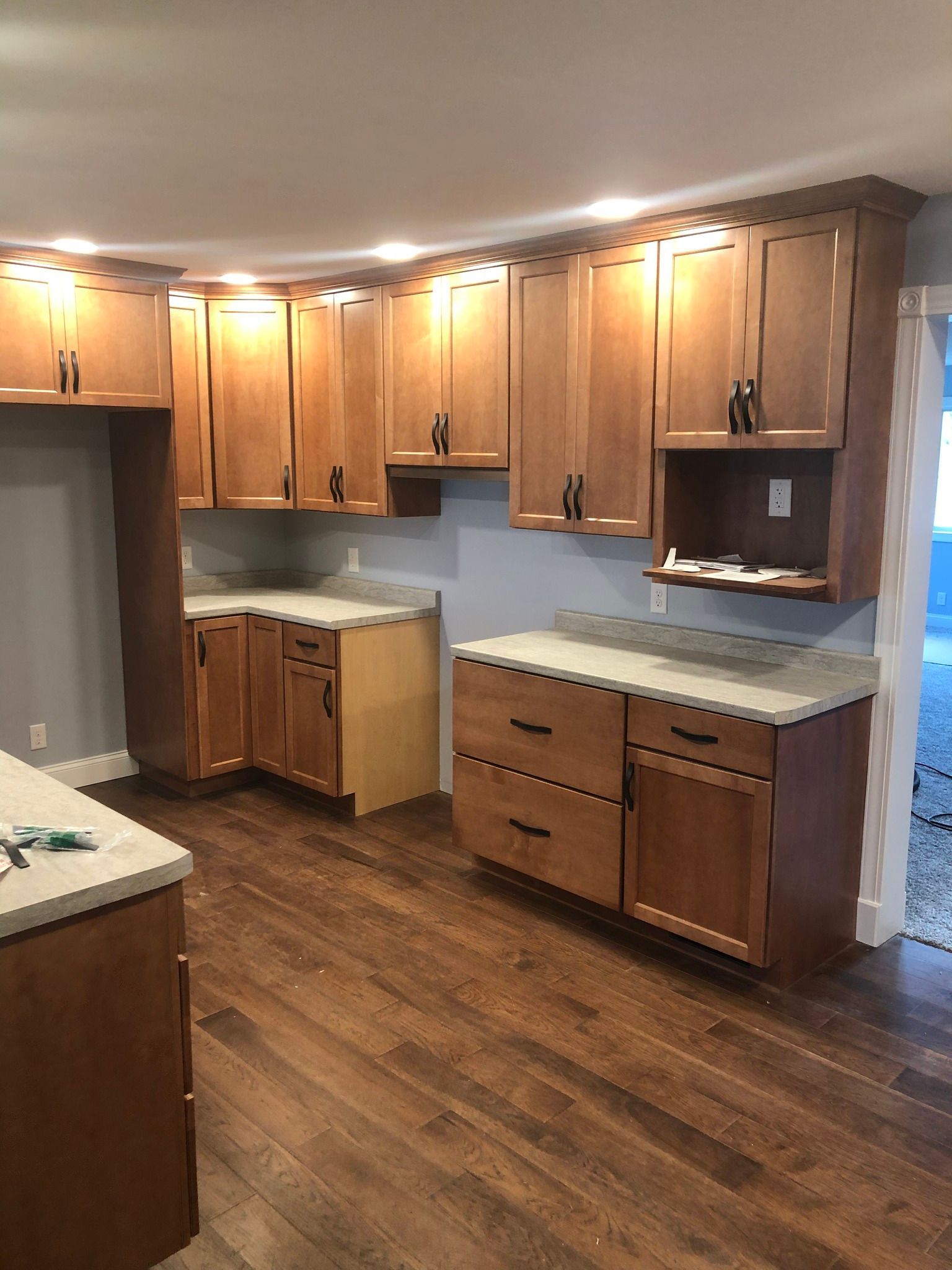 A kitchen with wooden cabinets and granite counter tops