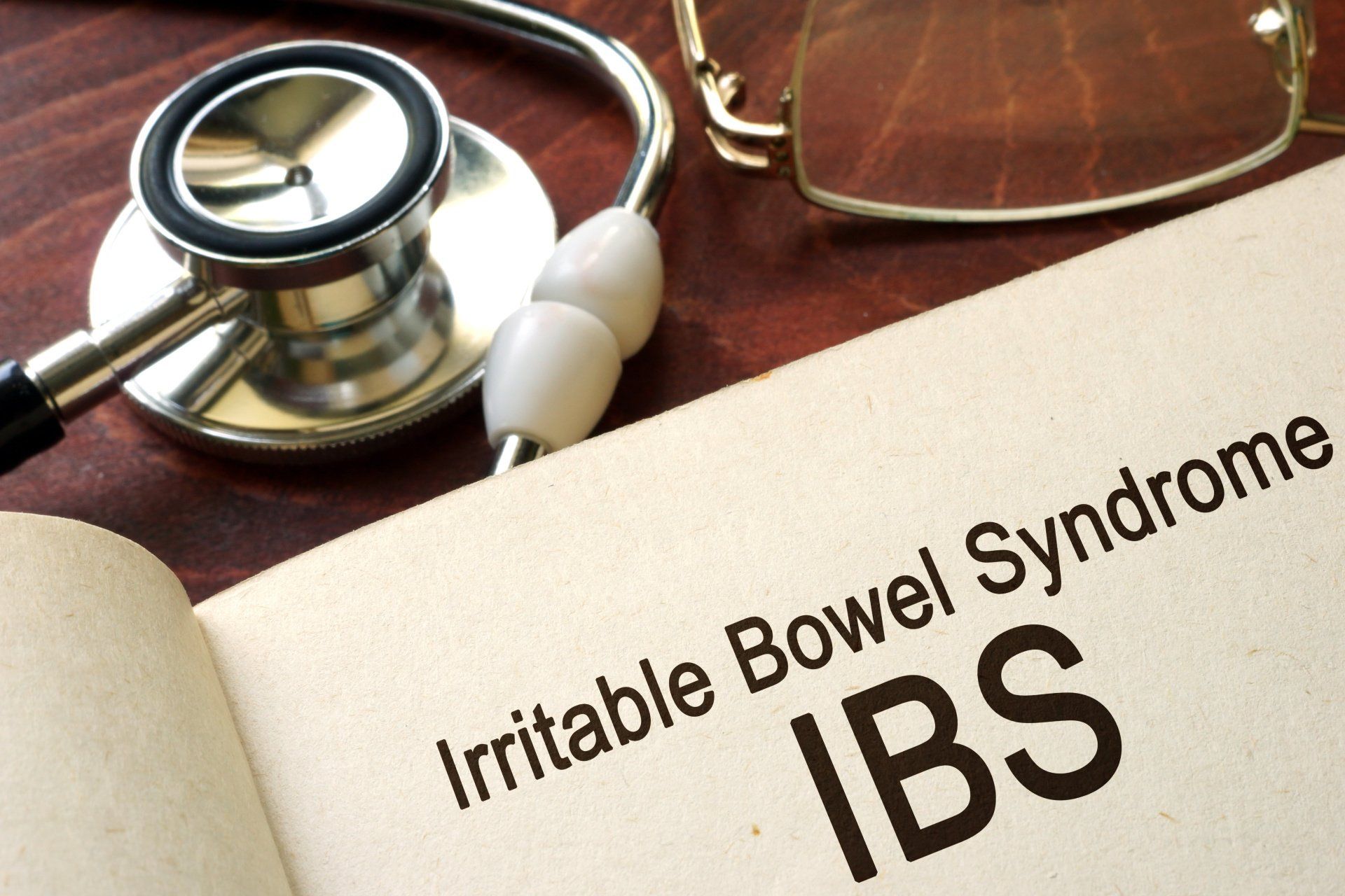 A book is open to a page that says irritable bowel syndrome ibs