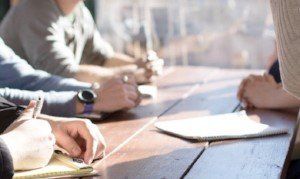 Meeting at desk. Setting up coach-mentoring schemes for doctors.