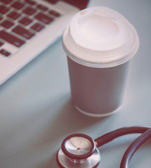 Stethoscope, coffee and computer. Supporting medics through career development and decisions, one-to-on coaching for doctors and developing mentoring programmes for doctors.