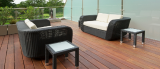 A wooden deck with a couch and chairs on it