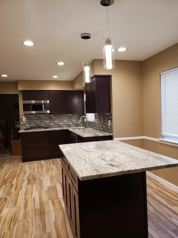 A kitchen with a large island in the middle of the room.