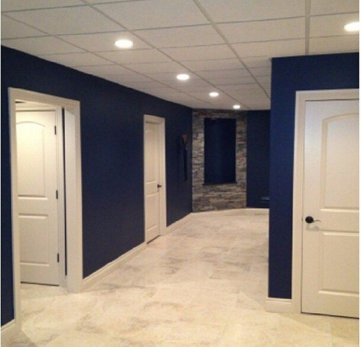 A hallway with blue walls and white doors
