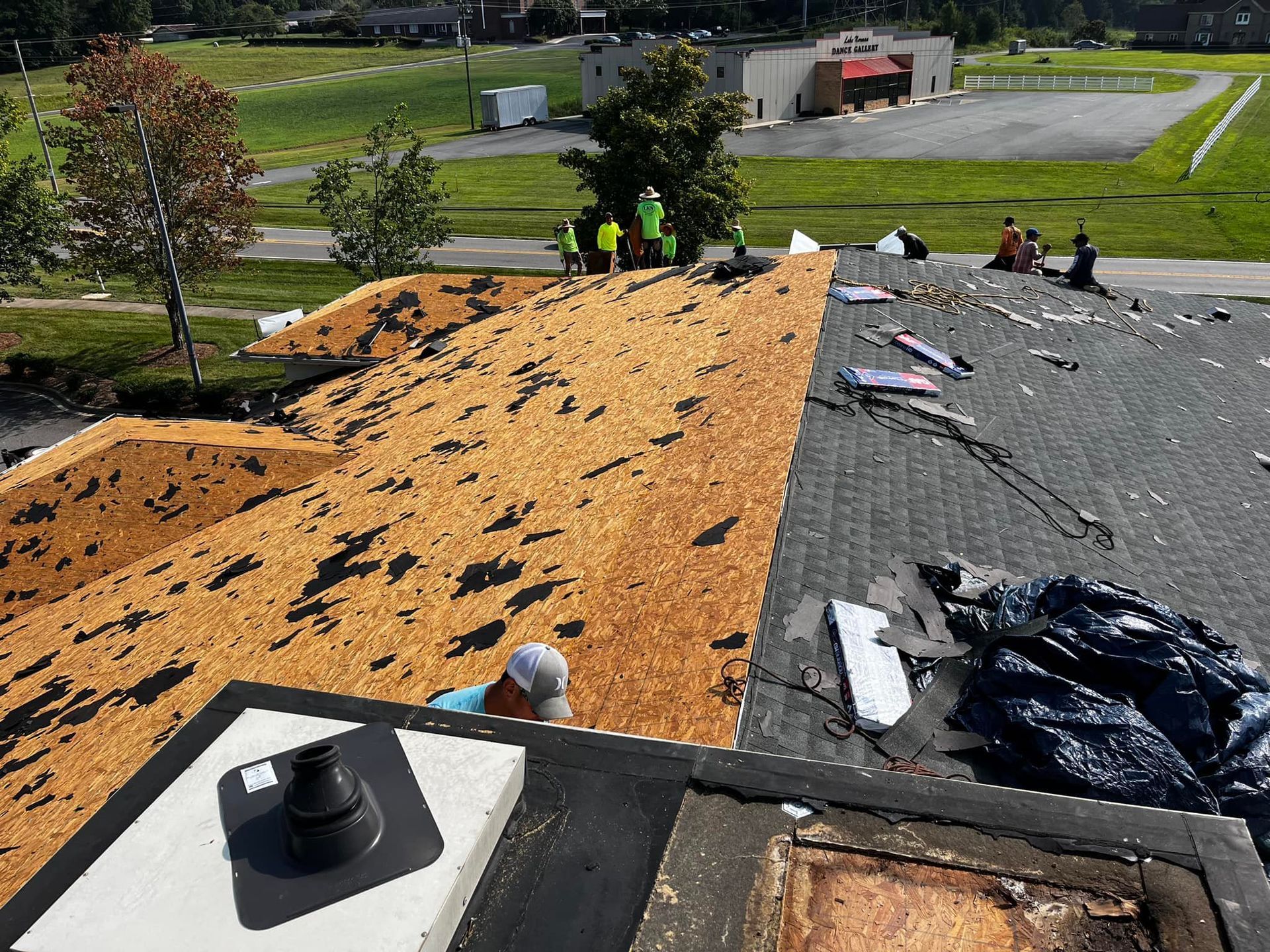 A roof with a lot of shingles on it is being repaired.