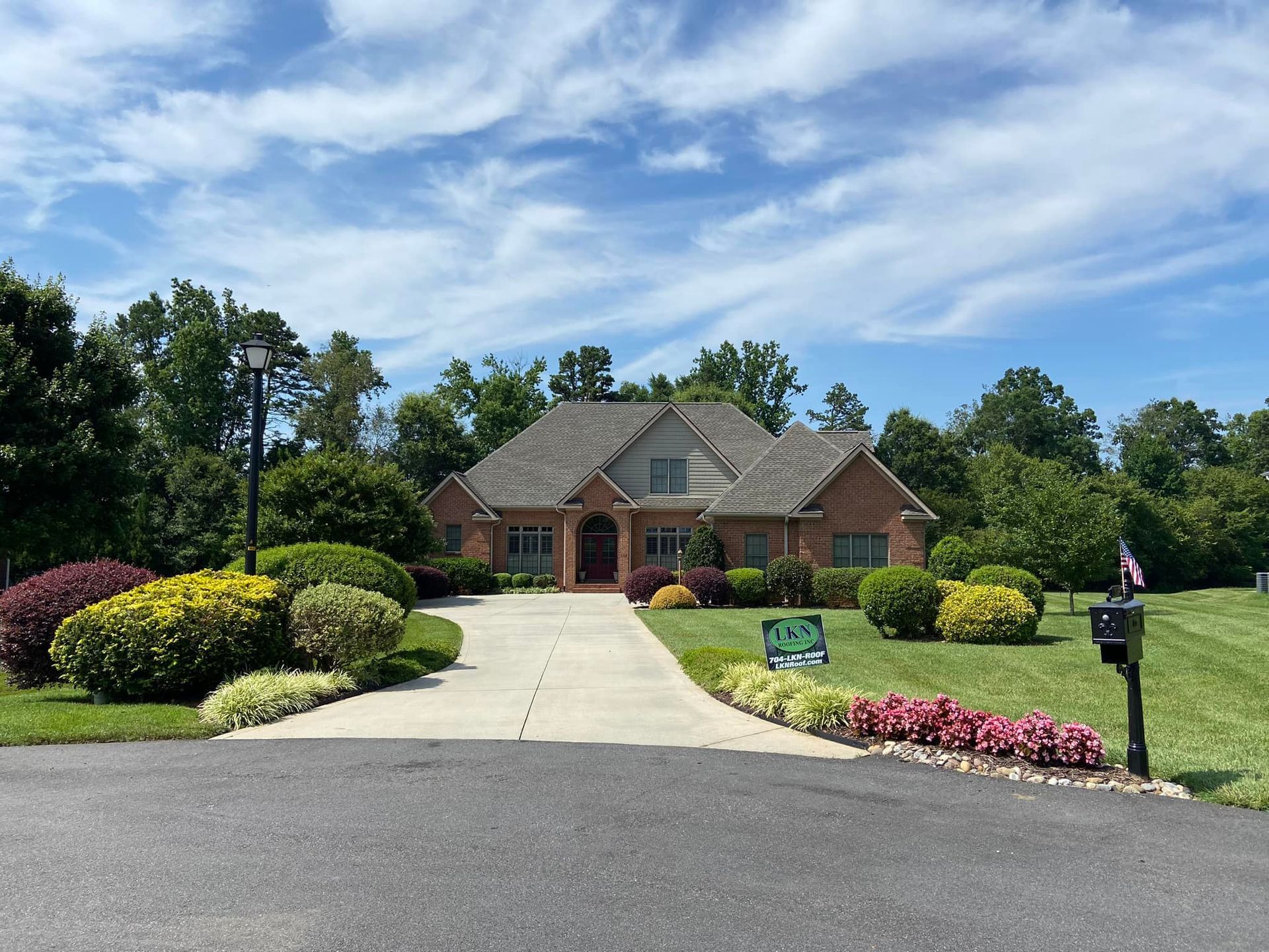 A large brick house with a driveway leading to it