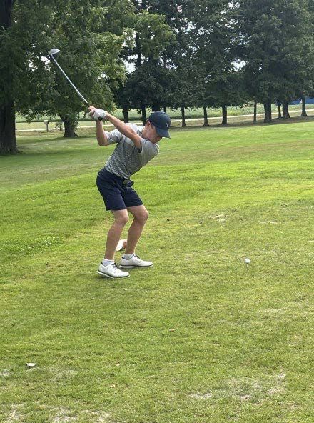 Asher swinging golf club back