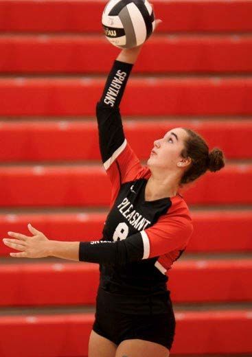 Kamryn palming volleyball back over net