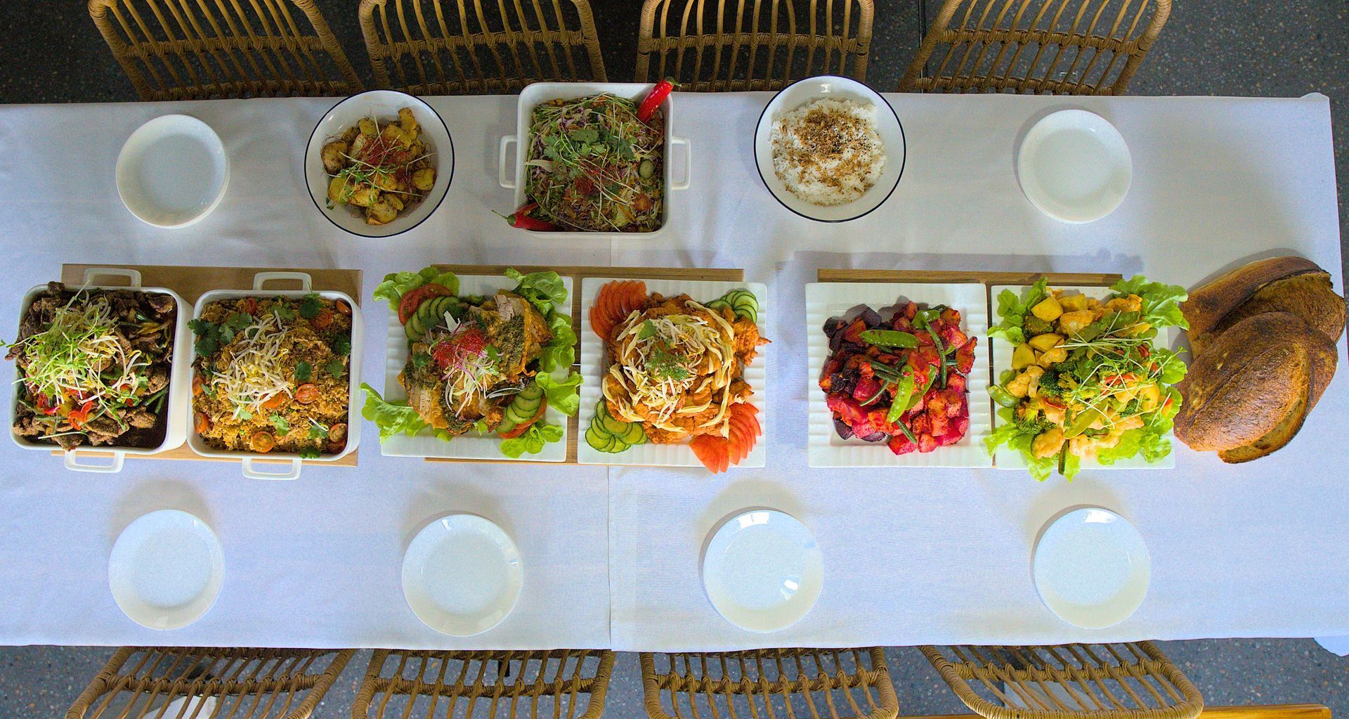 A Table Set for a Meal With Various Dishes of Food on White Plates — Lazy Paul's Cafe 'n Smokehouse In Wauchope, NSW