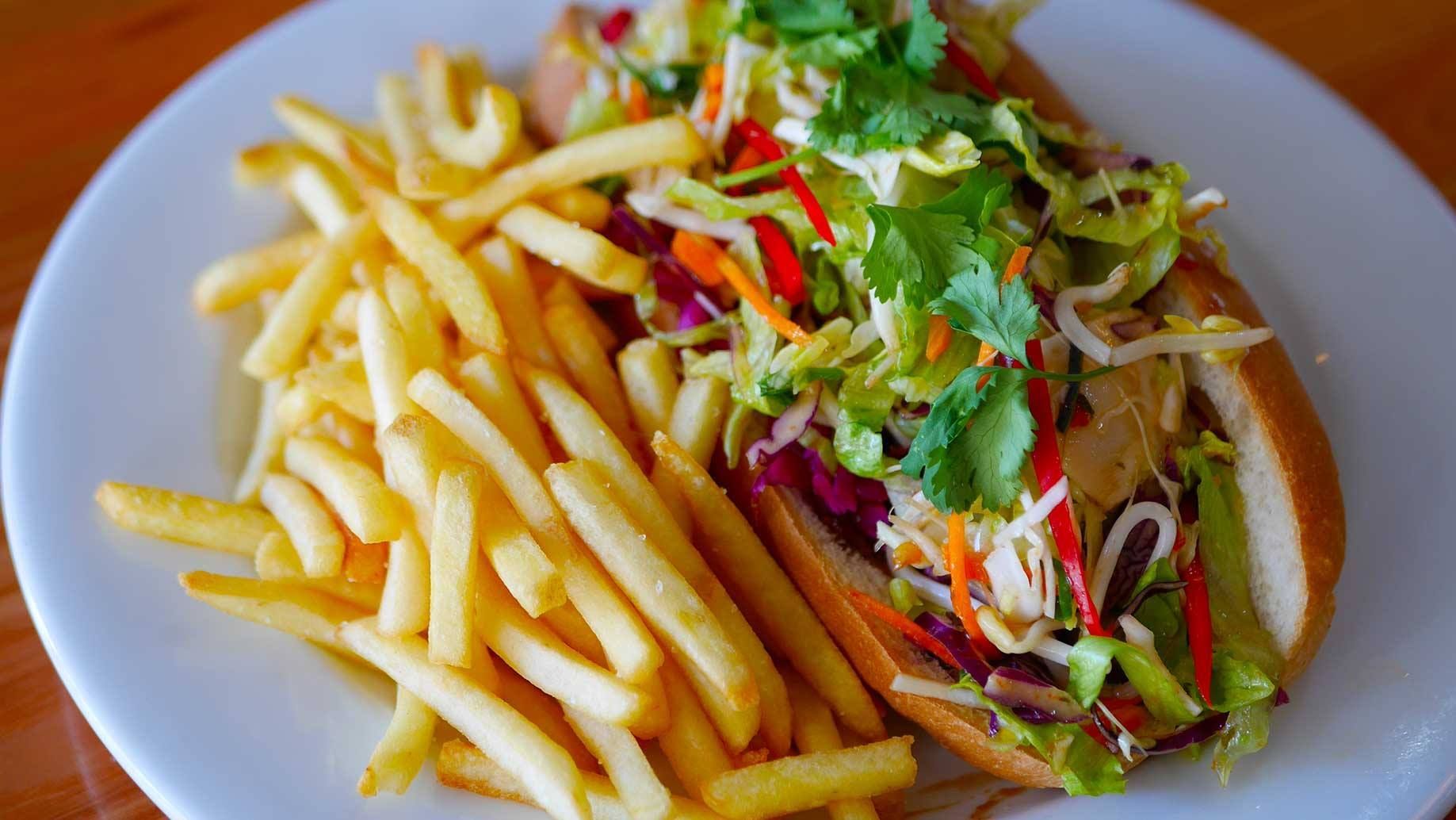 Bahn mi sandwich with fries on a white plate. — Lazy Paul's Cafe 'n Smokehouse In Wauchope, NSW