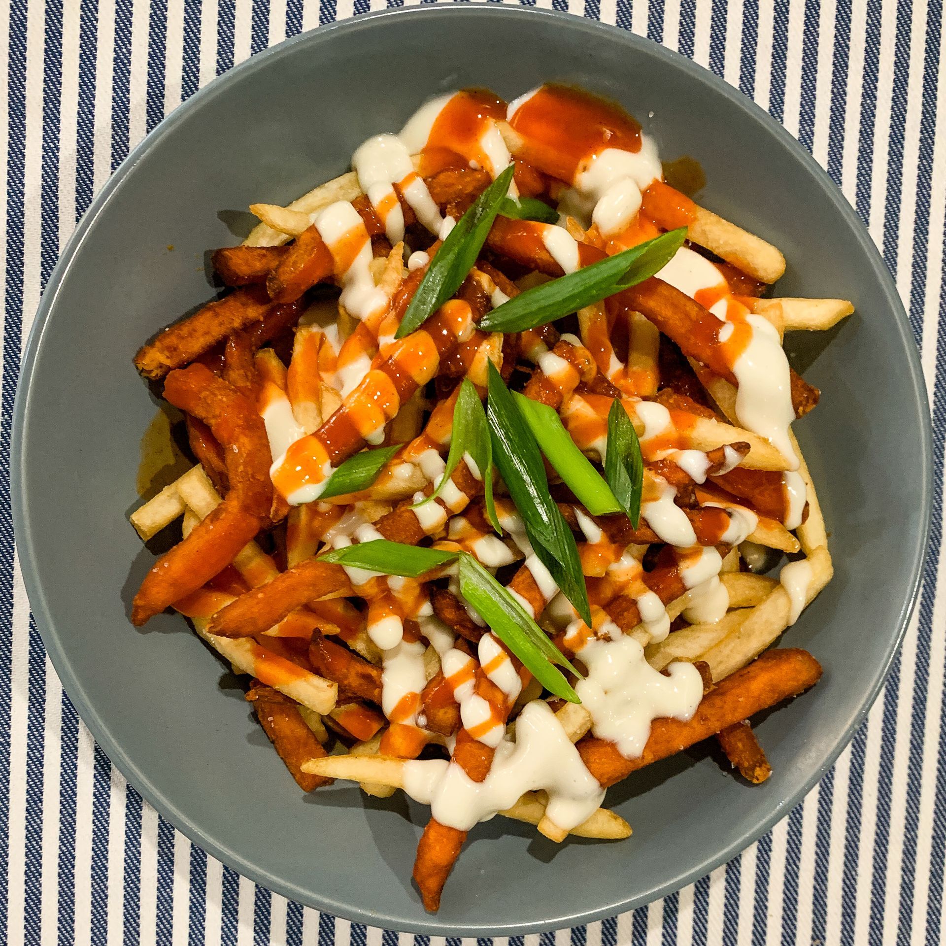 Fries in a Grey Bowl, Topped With Sauce, White Drizzle — Lazy Paul's Cafe 'n Smokehouse In Wauchope, NSW