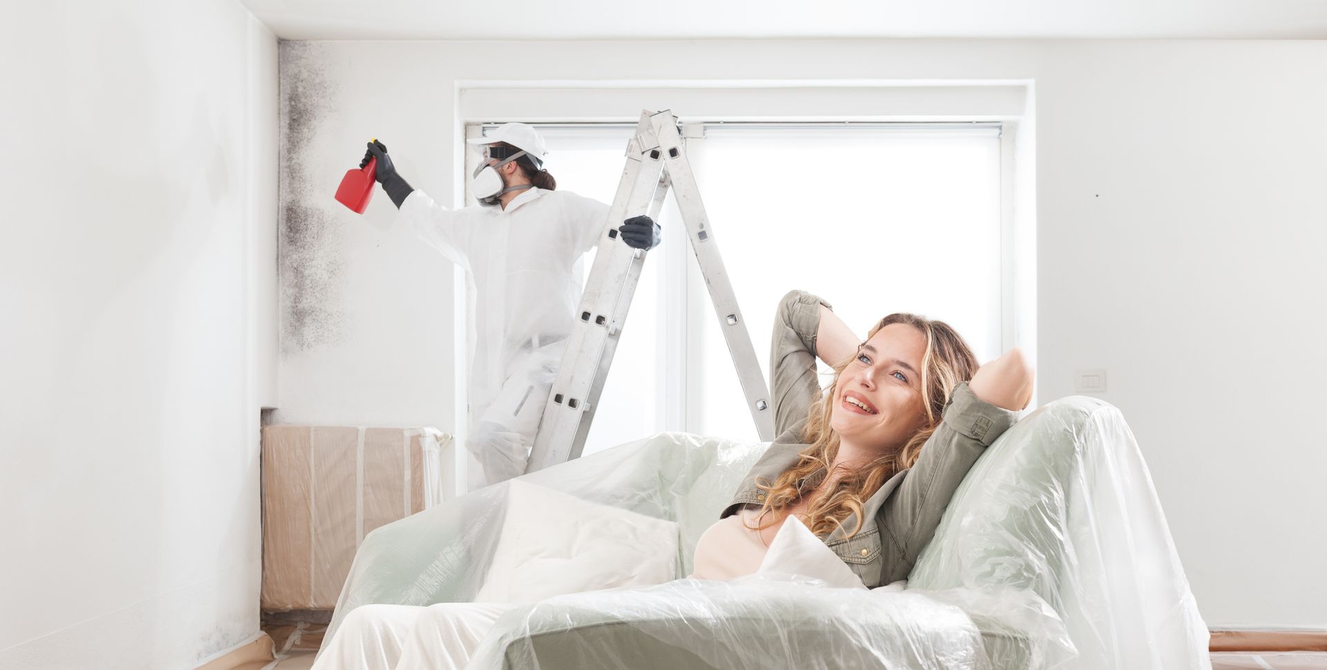 Mold remediation in progress; woman confident in safe, effective treatment. Mold remediation in progress; woman confident in safe, effective treatment.