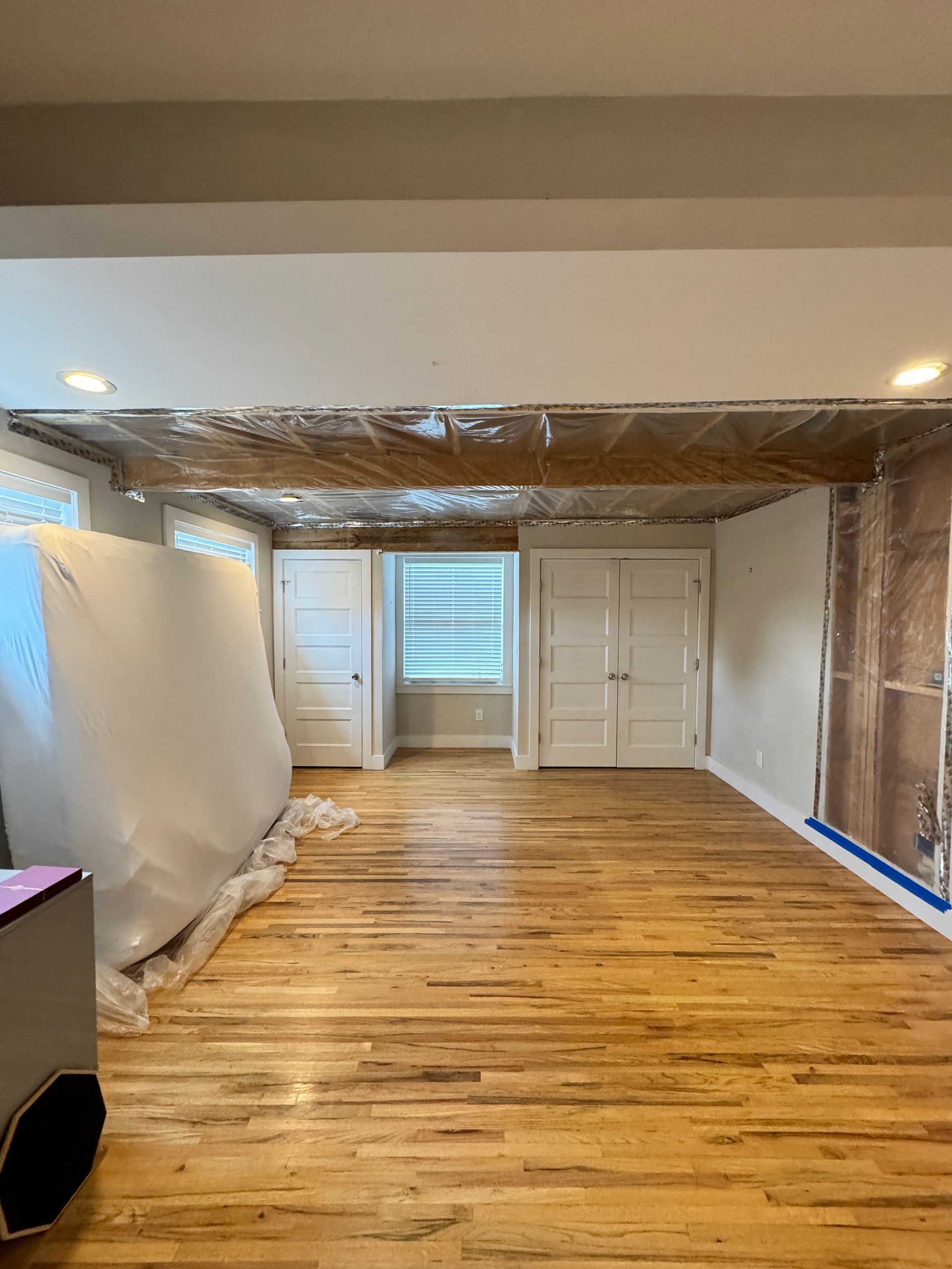 A picture of a man and woman is hanging on a wall next to a ceiling.