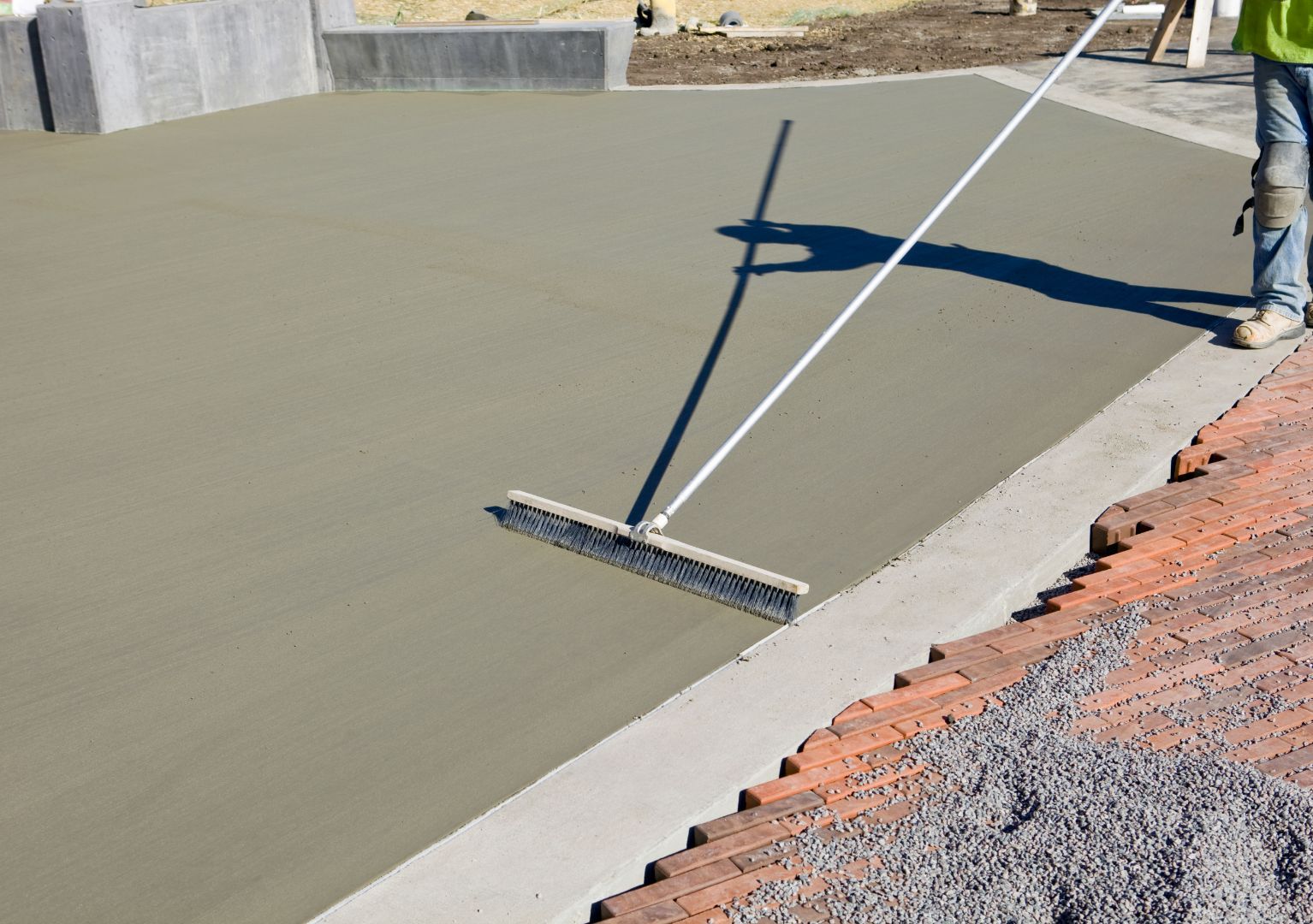 An image of a concrete slab being installed and smoothed in Morrisville, NC