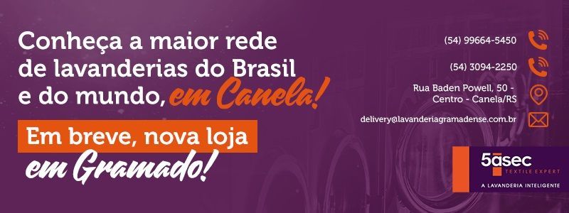 A purple sign that says conheca a maior rede de lavanderias do brasil e do mundo em canola