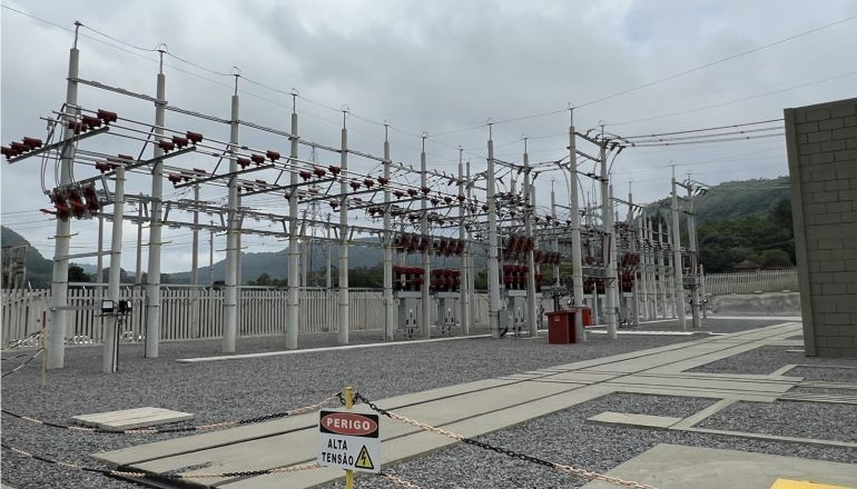 Uma central eléctrica com um sinal de aviso à sua frente.