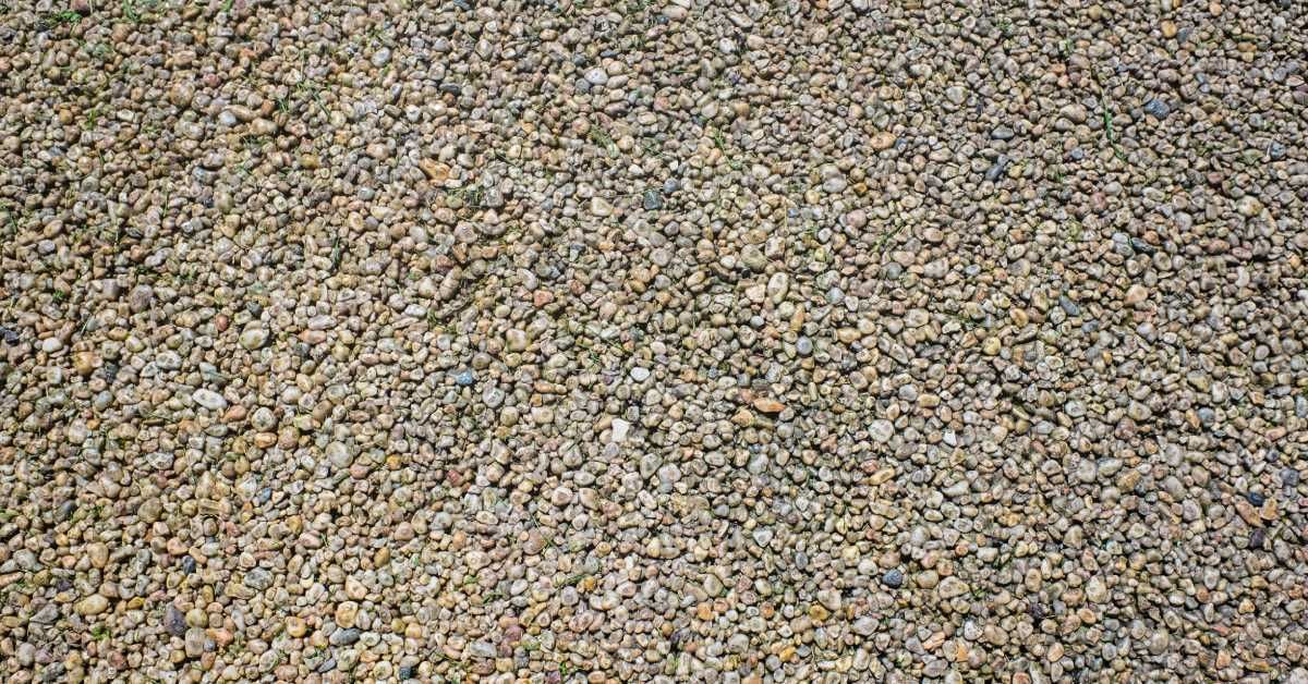 A closeup of compacted paving resin in various shades of brown, black, and other neutral colors.