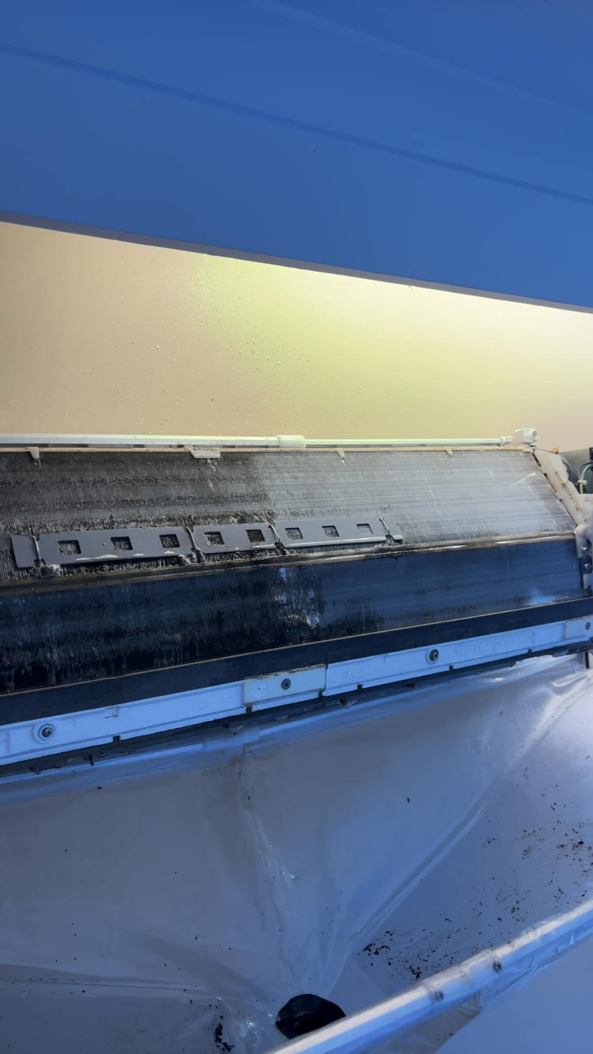 A Heavily Soiled Air Conditioning Unit With Black Debris — BNS Refrigeration Services in Healy, QLD