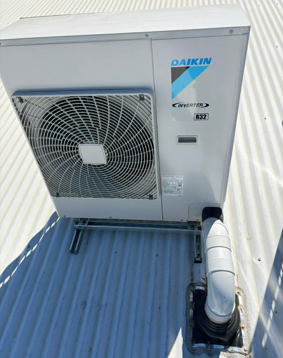 A Daikin Heat Pump Unit on a Corrugated Metal Roof — BNS Refrigeration Services in Healy, QLD