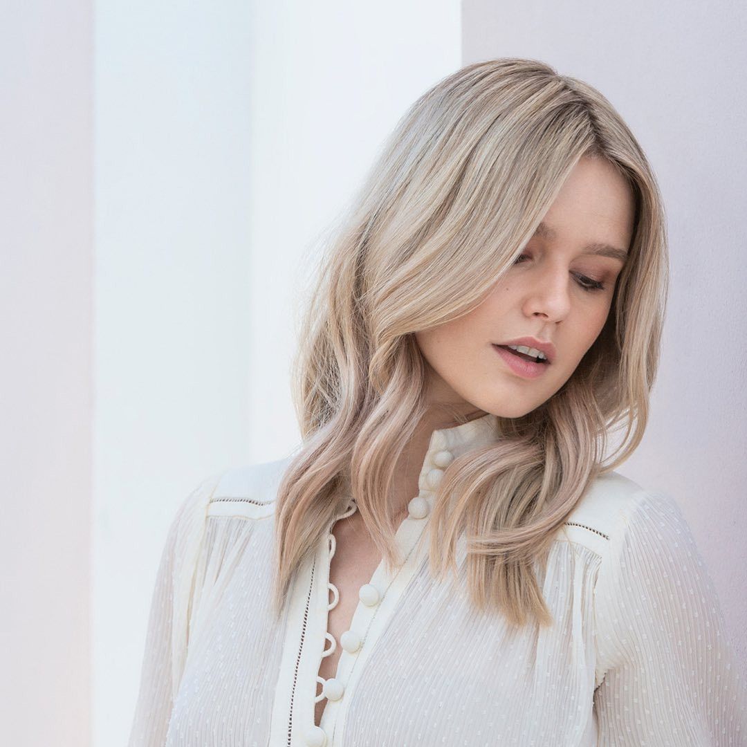 A Woman Is Having Her Hair Styled By A Hairdresser — Sophisticut Hair Salon in Mysterton, QLD