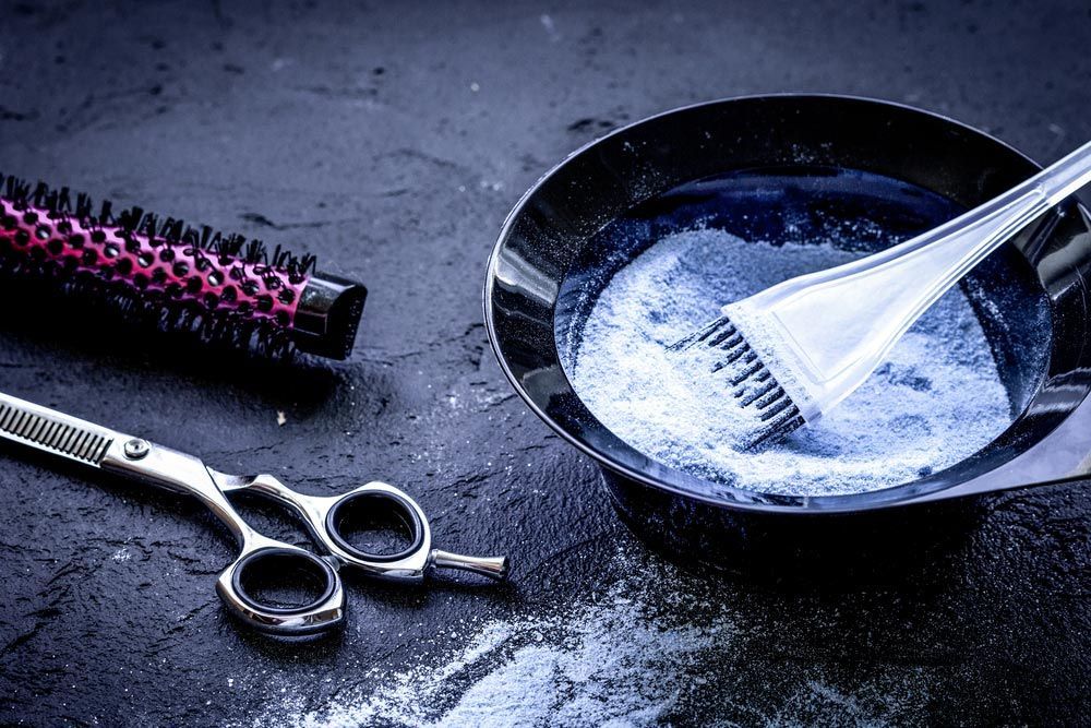 A Pair of Scissors, a Brush and a Bowl of Hair Dye on a Table — Sophisticut Hair Salon in Mysterton, QLD