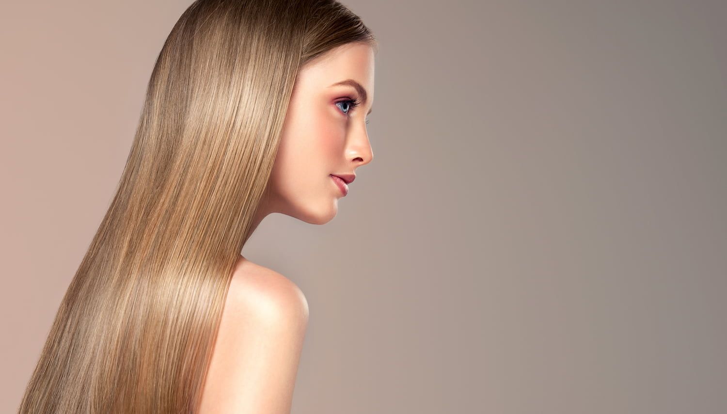 A Woman With Long Blonde Hair is Looking at the Camera — Sophisticut Hair Salon in Mysterton, QLD