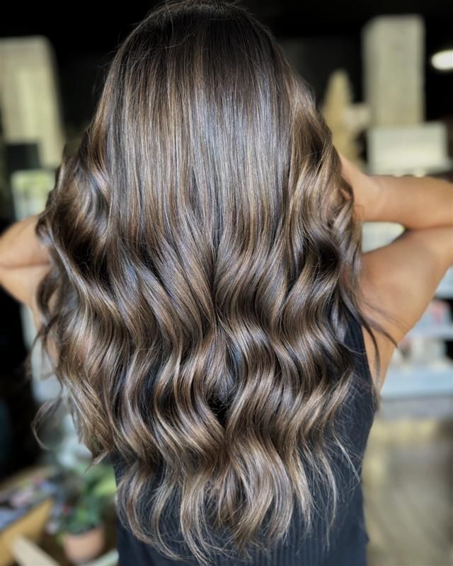 A Woman With Purple Hair Is Getting Her Hair Done By A Hairdresser — Sophisticut Hair Salon in Mysterton, QLD