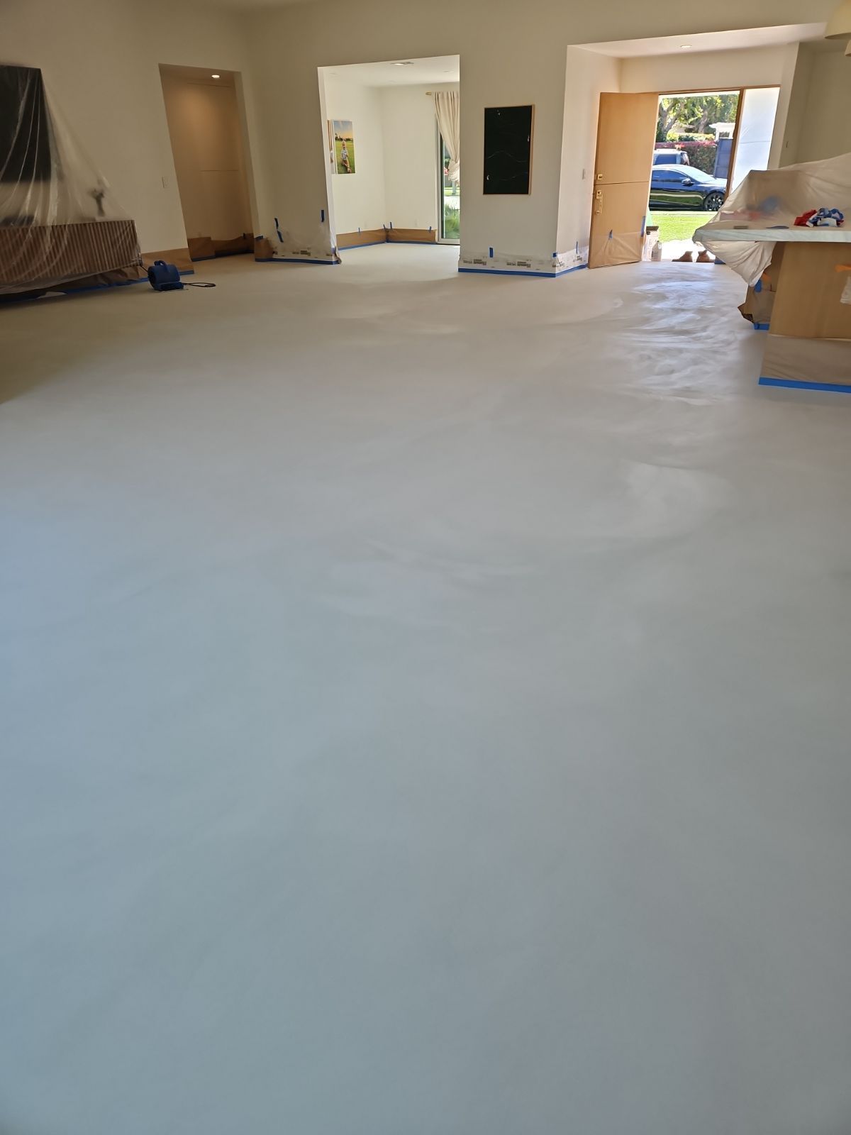 A living room with a white floor and a couch.