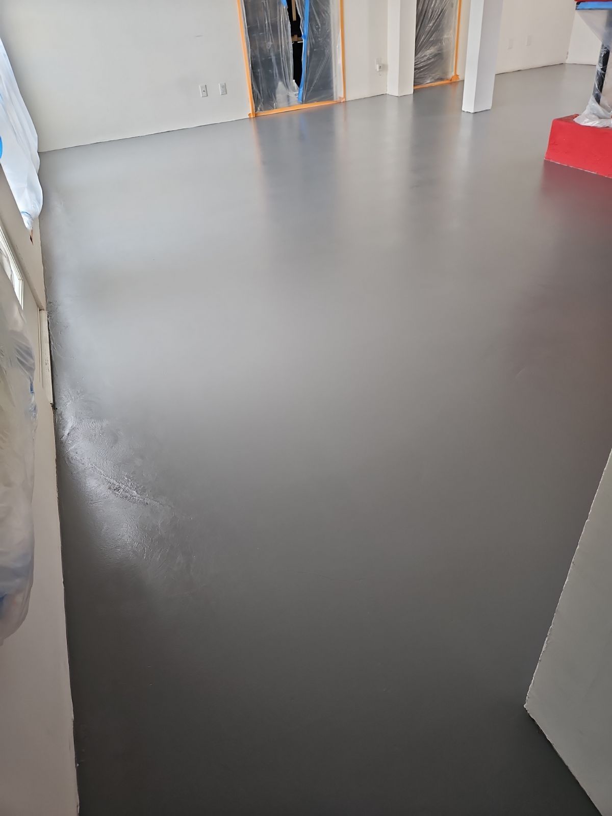 A large room with a gray floor and white walls.