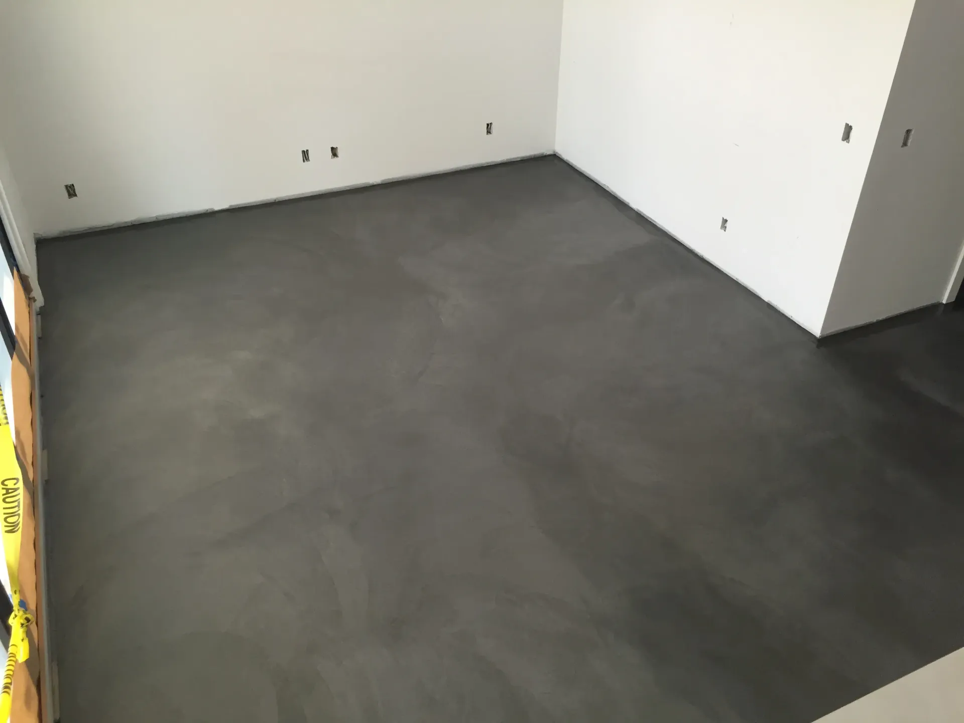 A room with a concrete floor and white walls.