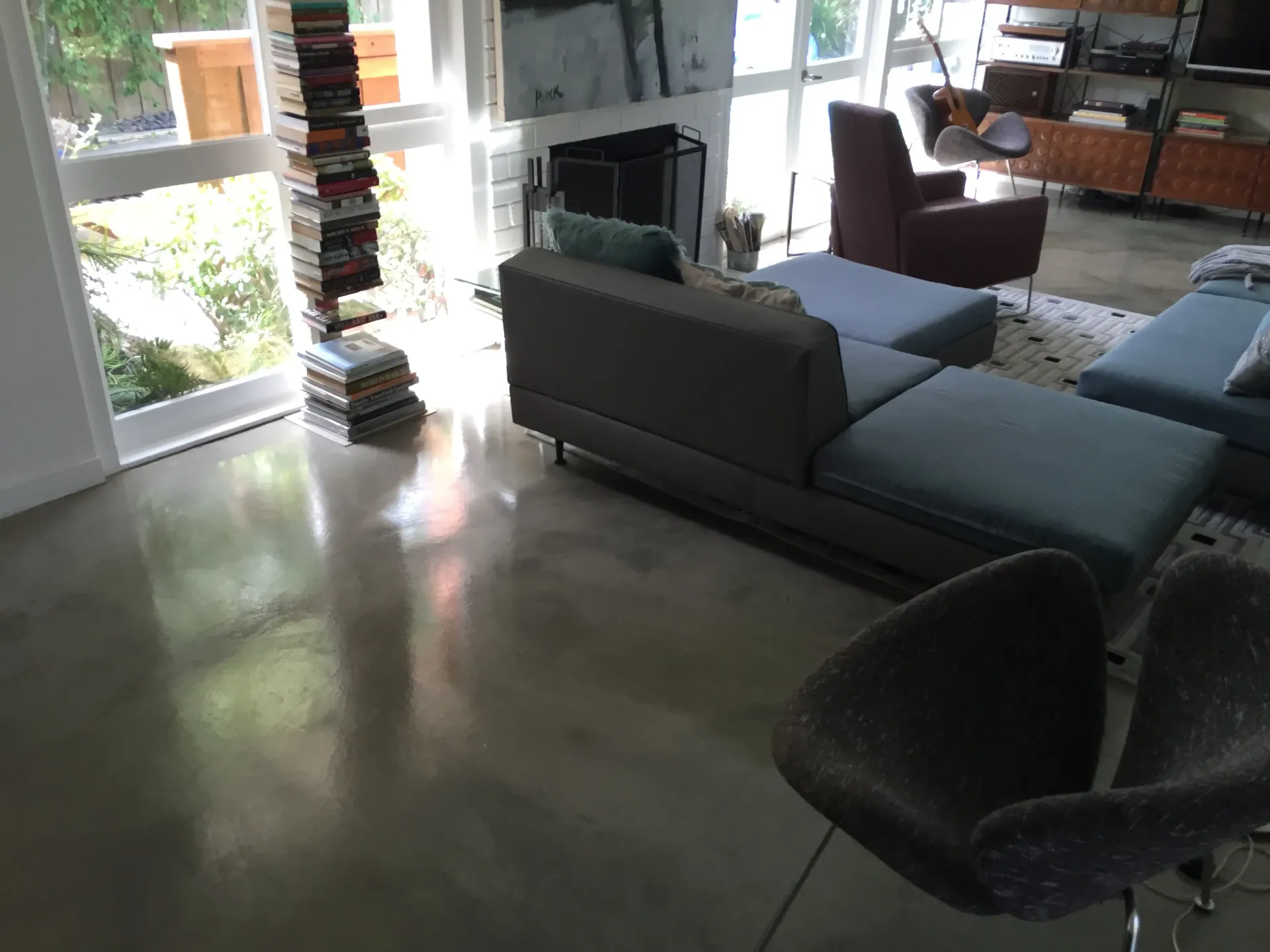 A living room with a couch ottoman and chairs
