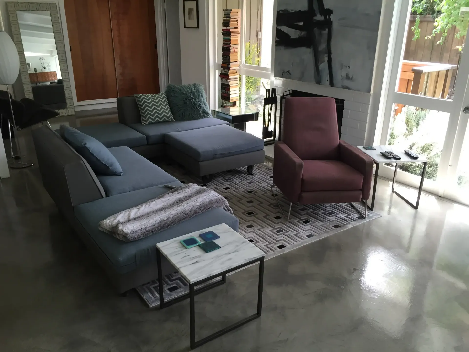 A living room with a large sectional couch and two chairs