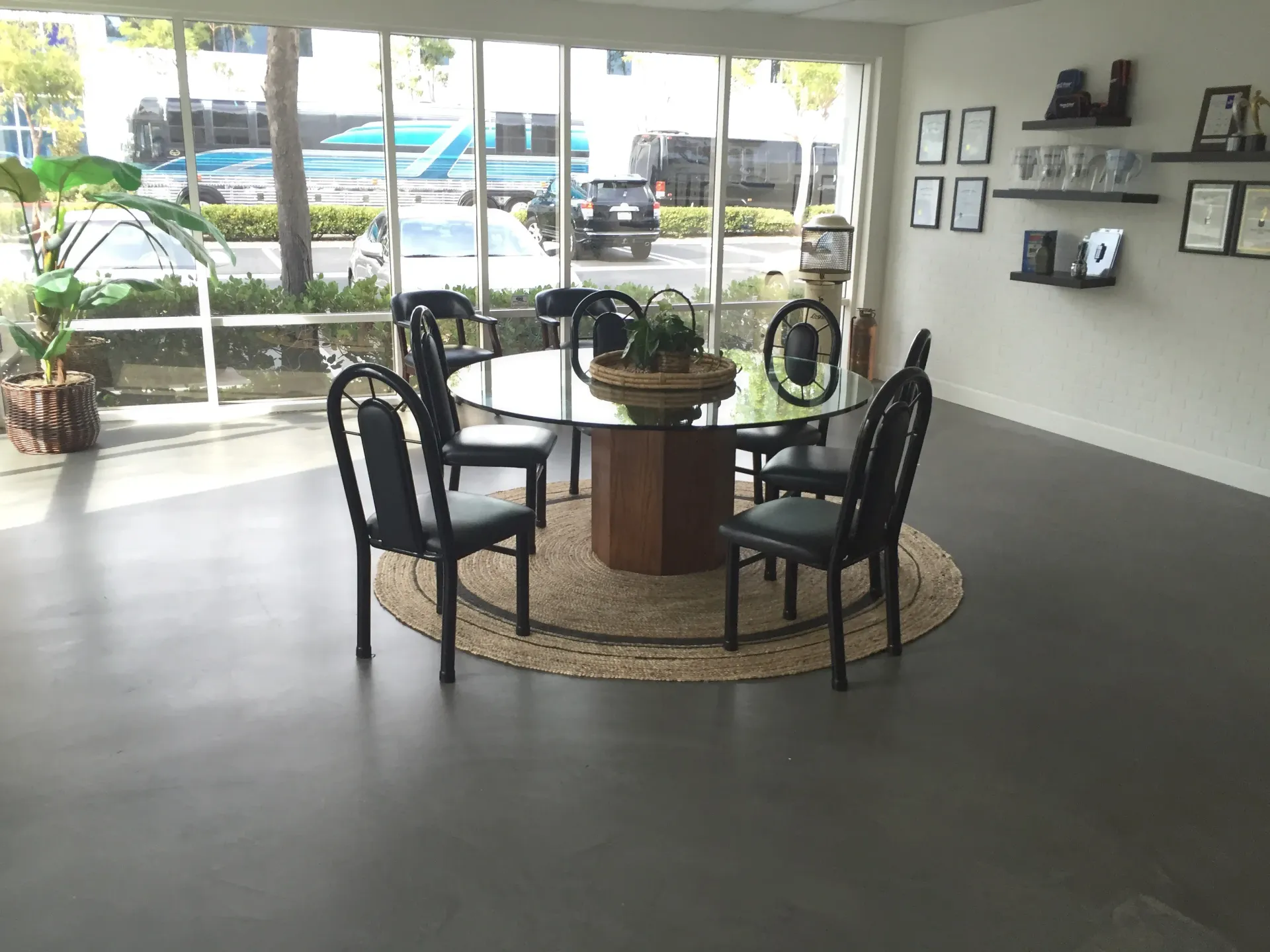 A room with a round table and chairs in it
