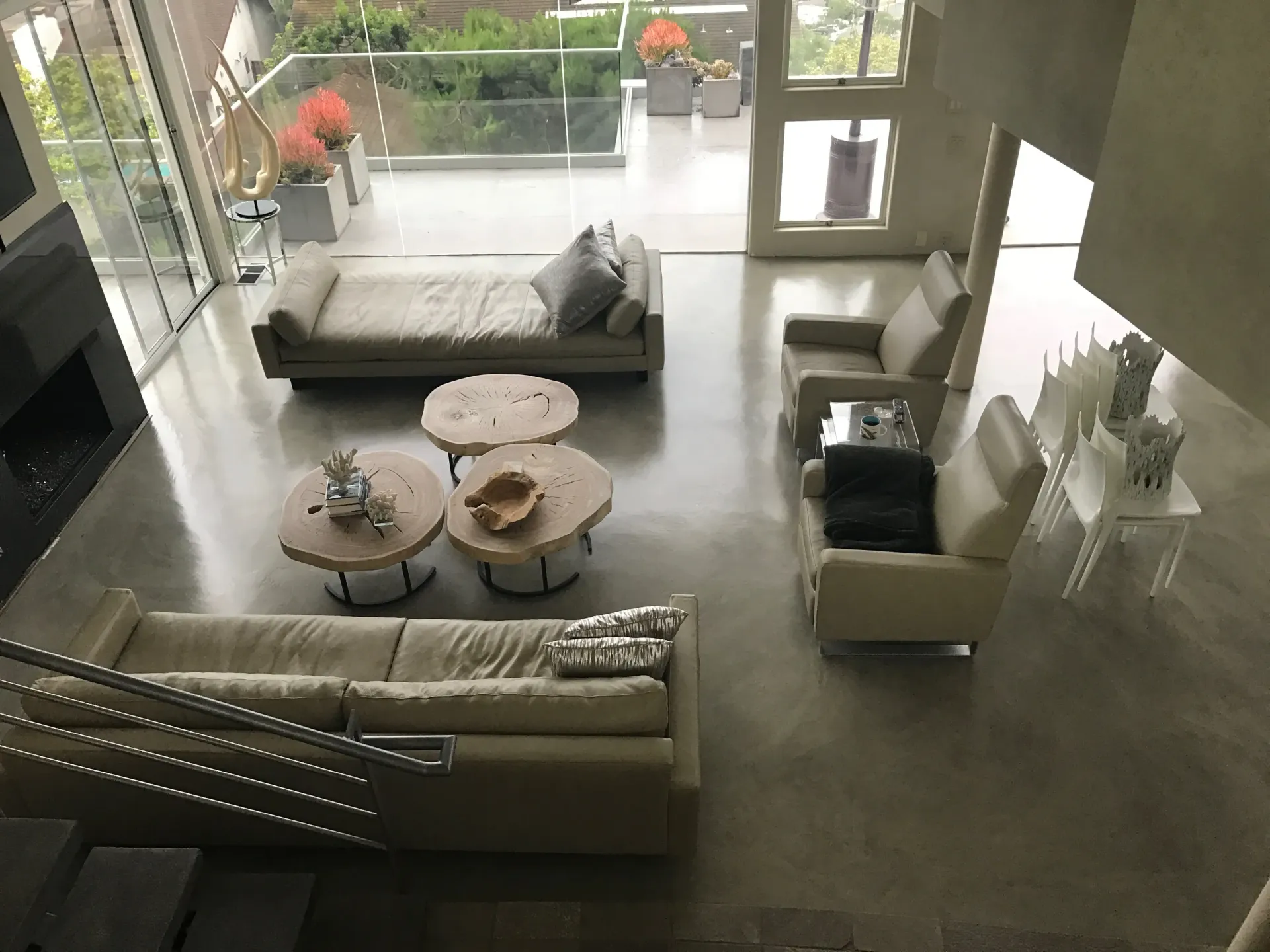 An aerial view of a living room with white furniture