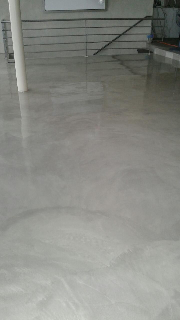 A white tiled floor with a staircase in the background.