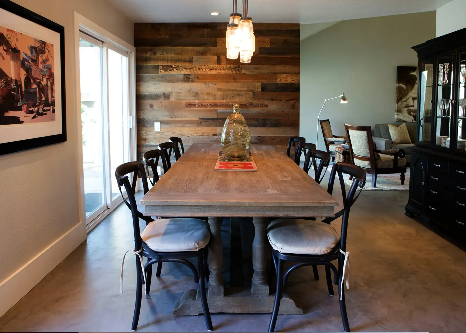 A dining room with a long wooden table and chairs