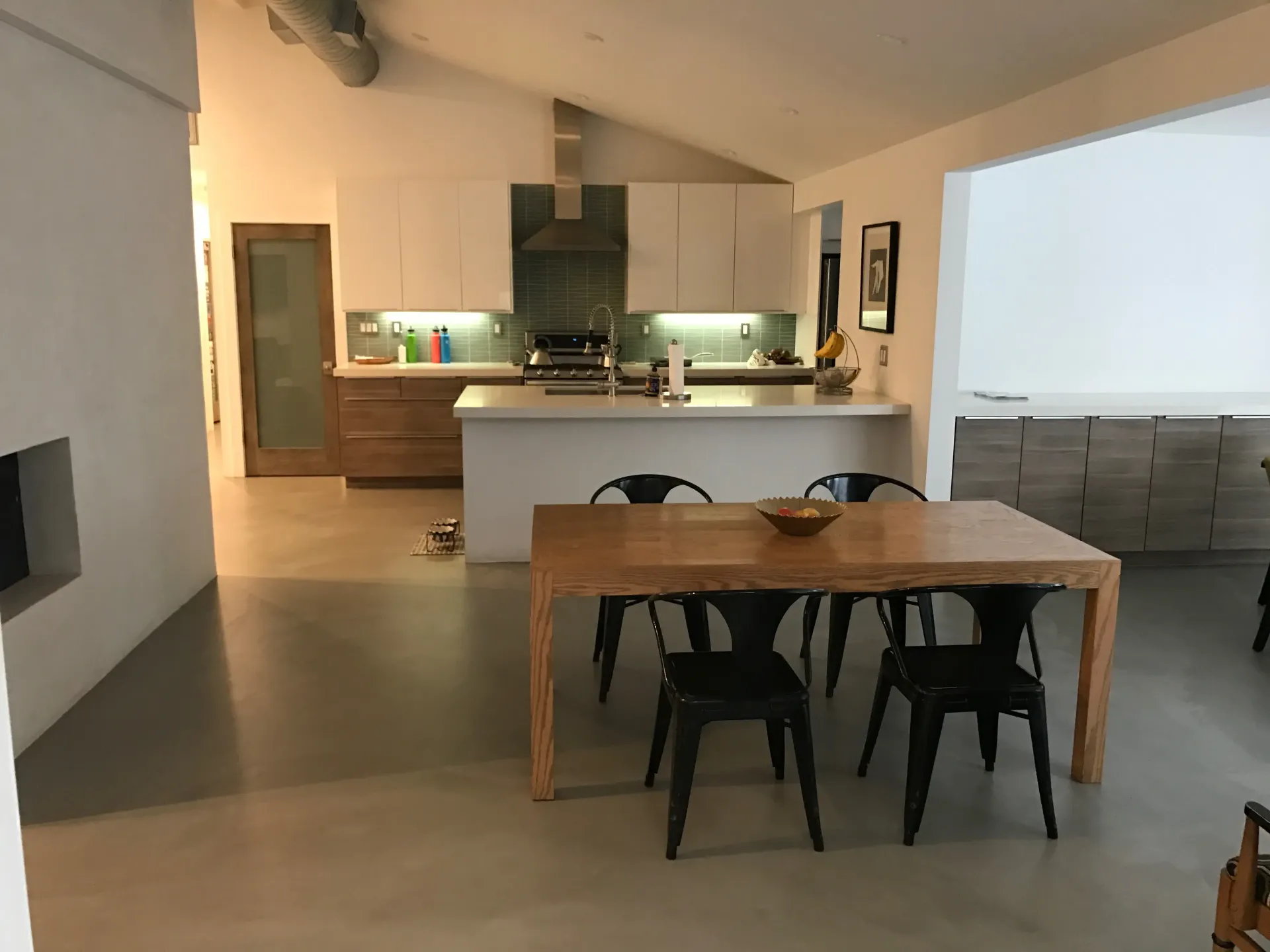 A kitchen with a table and chairs in it