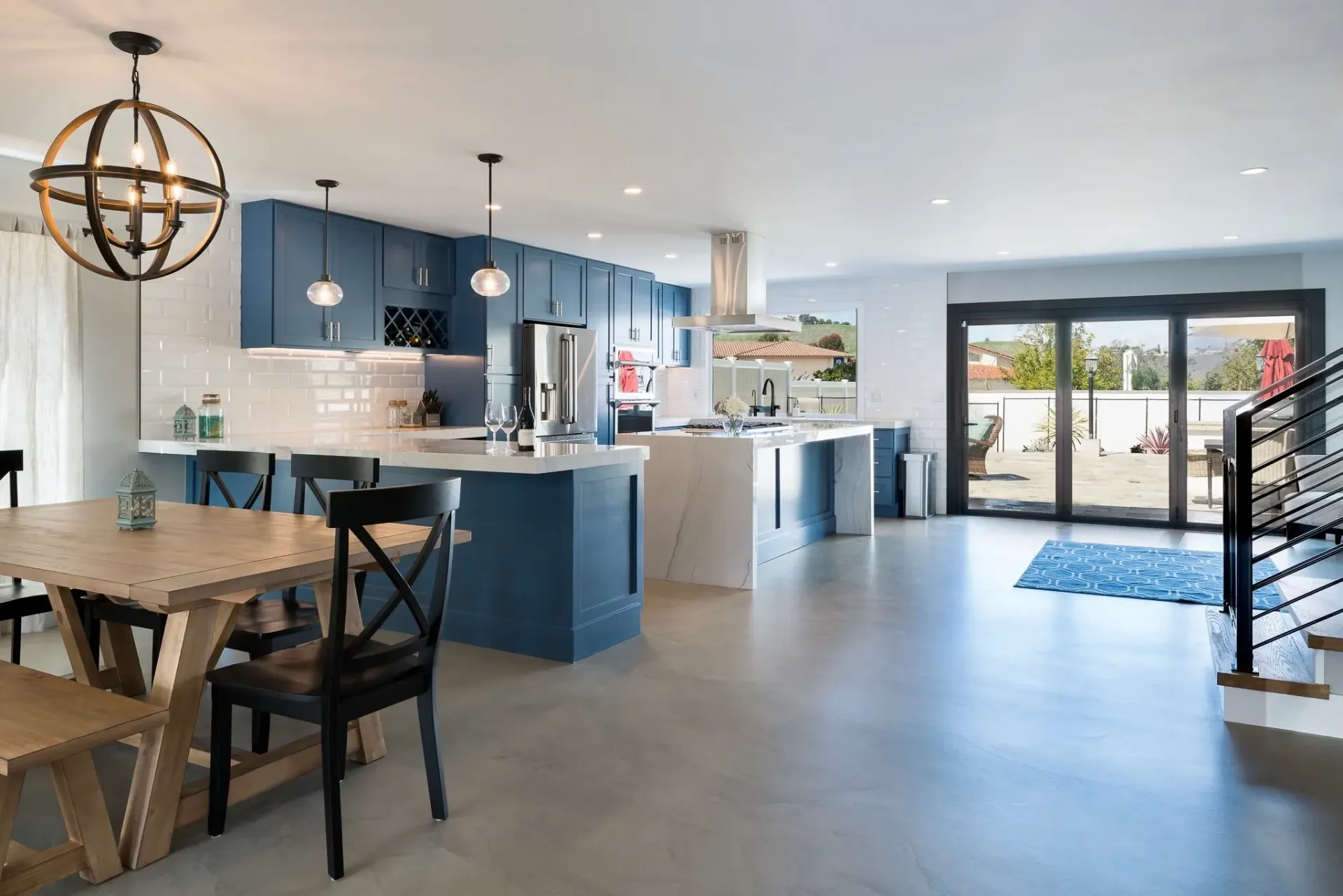 There is a table and chairs in the middle of the room.