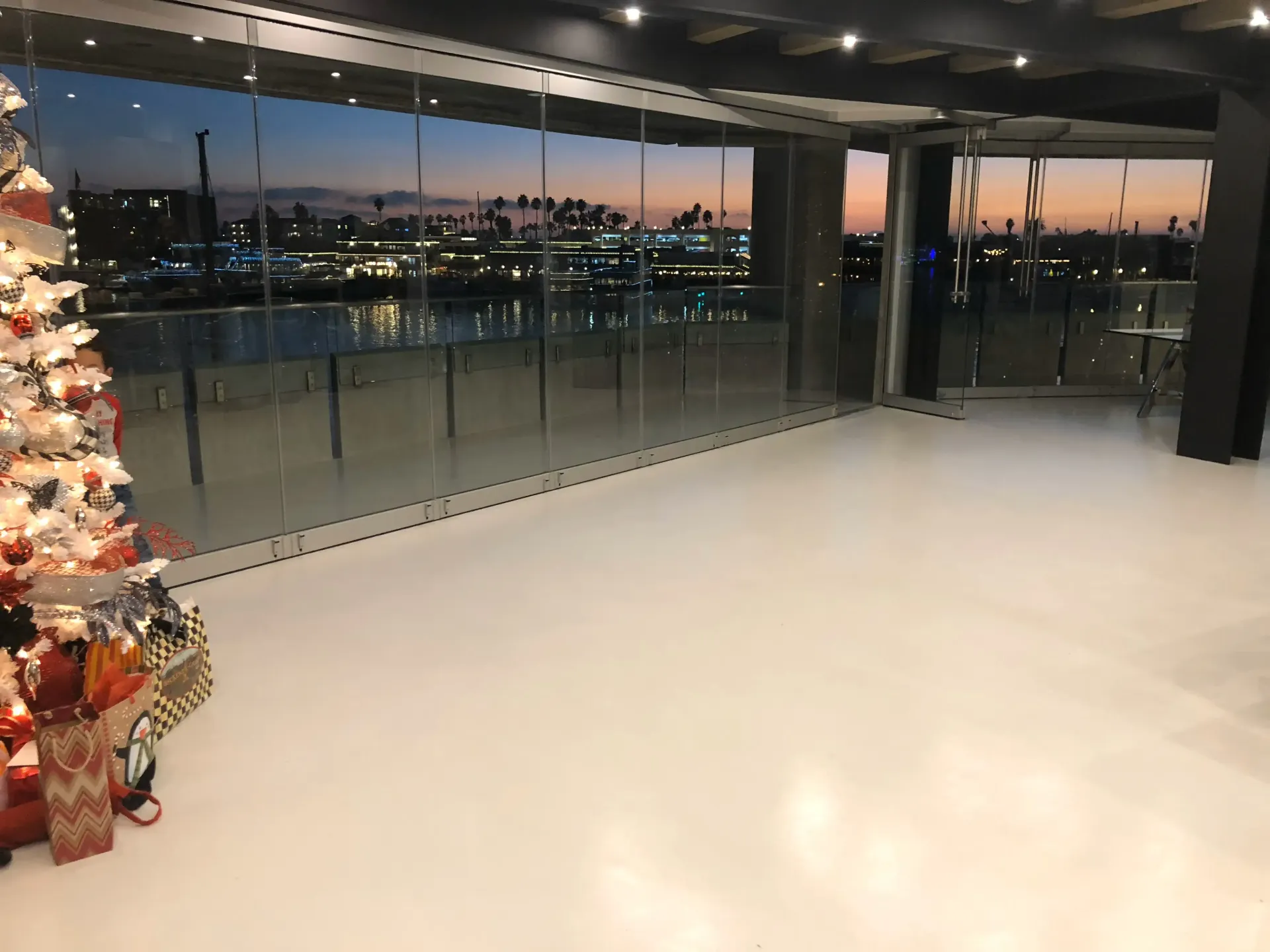 An empty room with a christmas tree in the middle of it