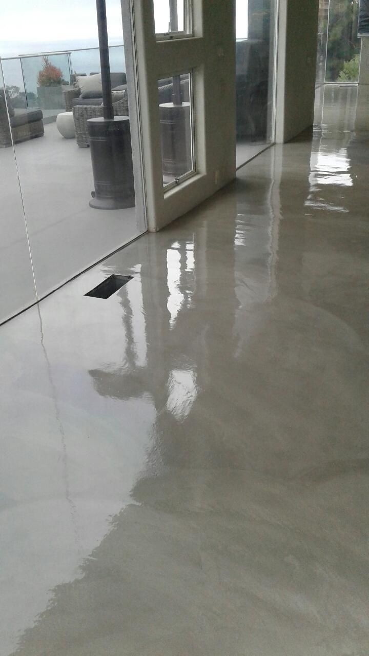 A room with a marble floor and a large window.