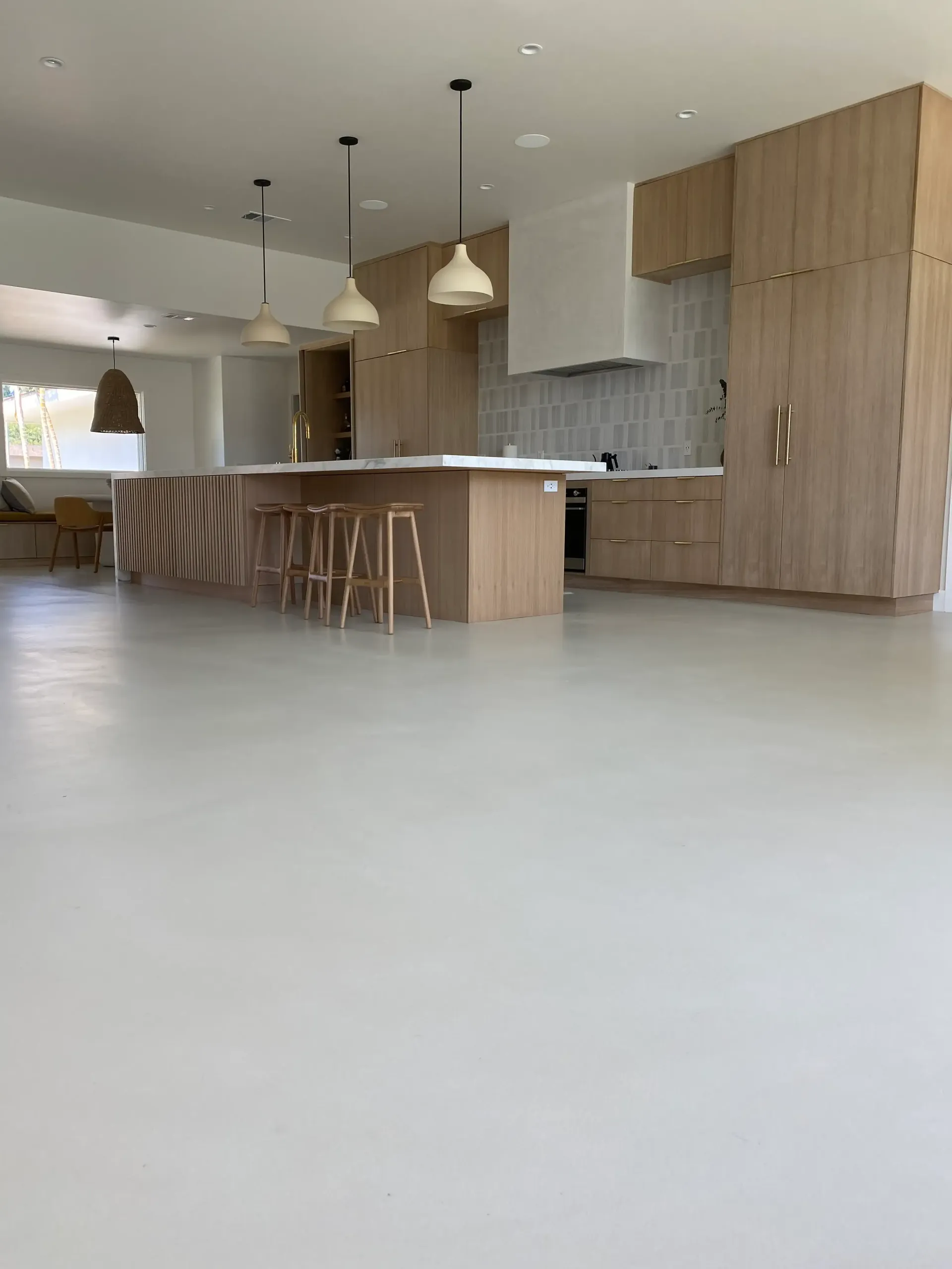 A kitchen with a large island and wooden cabinets.