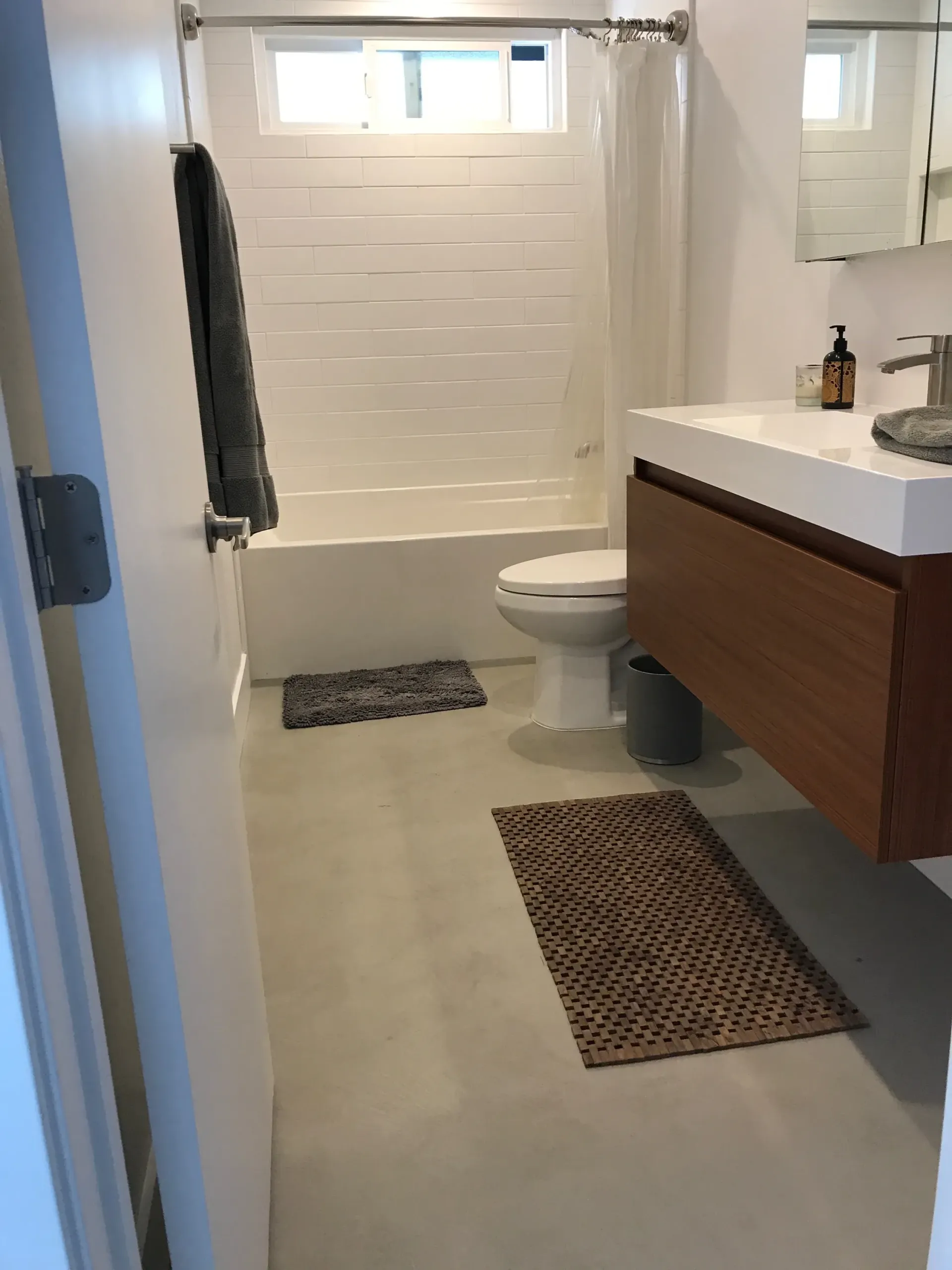 A bathroom with a toilet , sink , and bathtub.