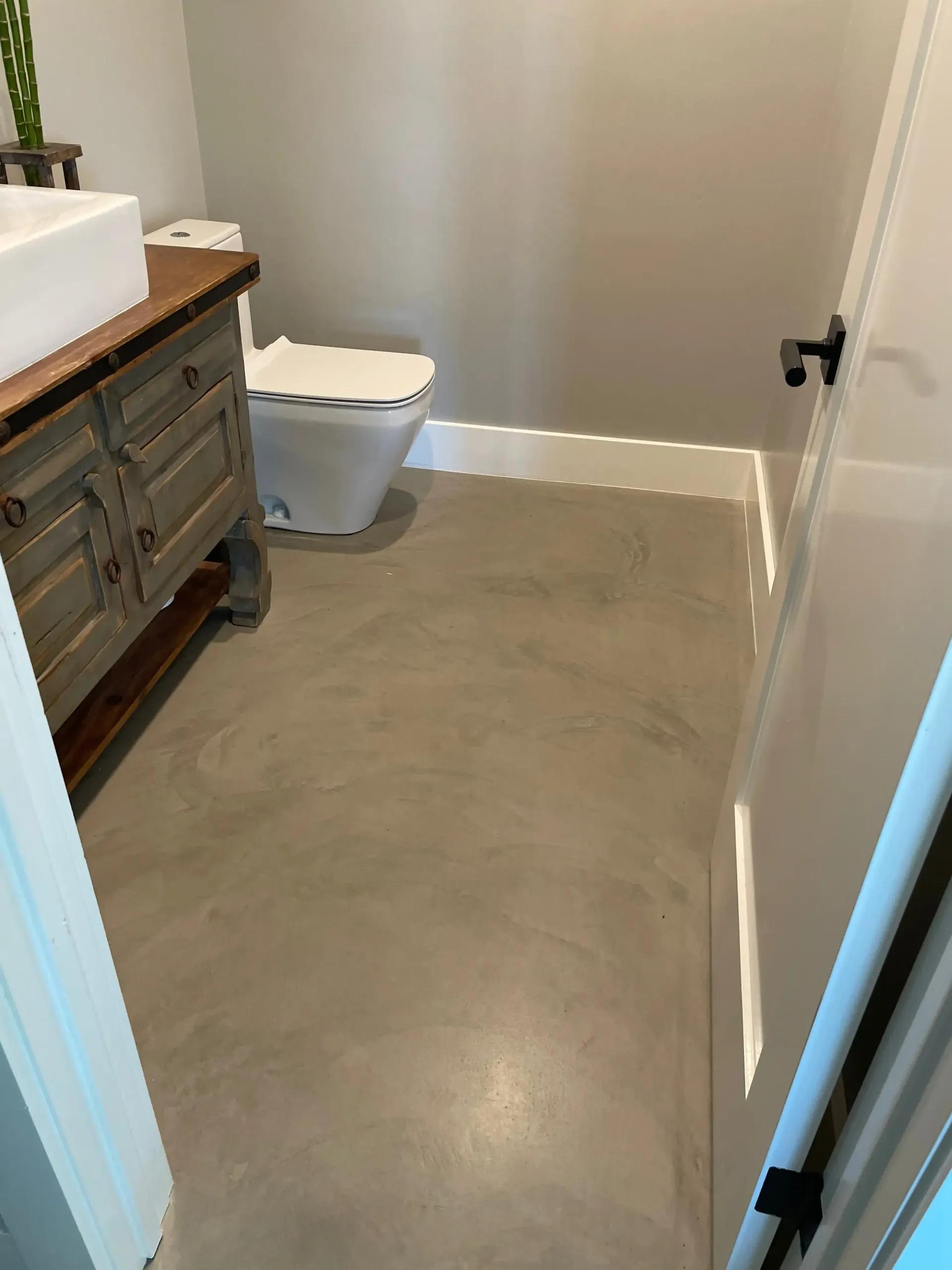 A bathroom with a sink , toilet , and vanity.