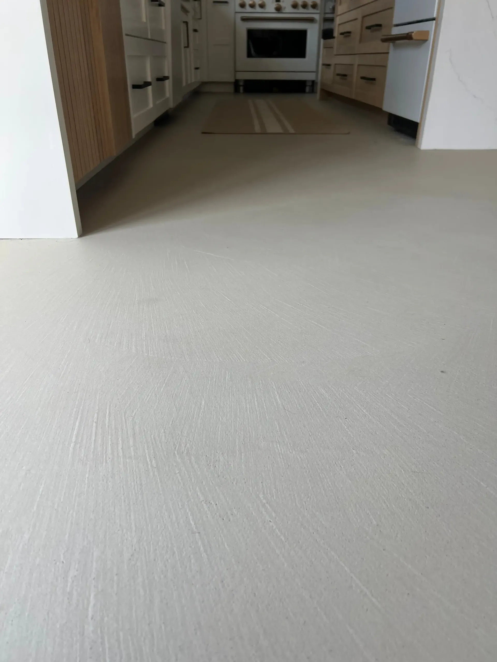 A kitchen with a white floor and a white stove.