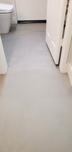 A bathroom with a toilet and a door.