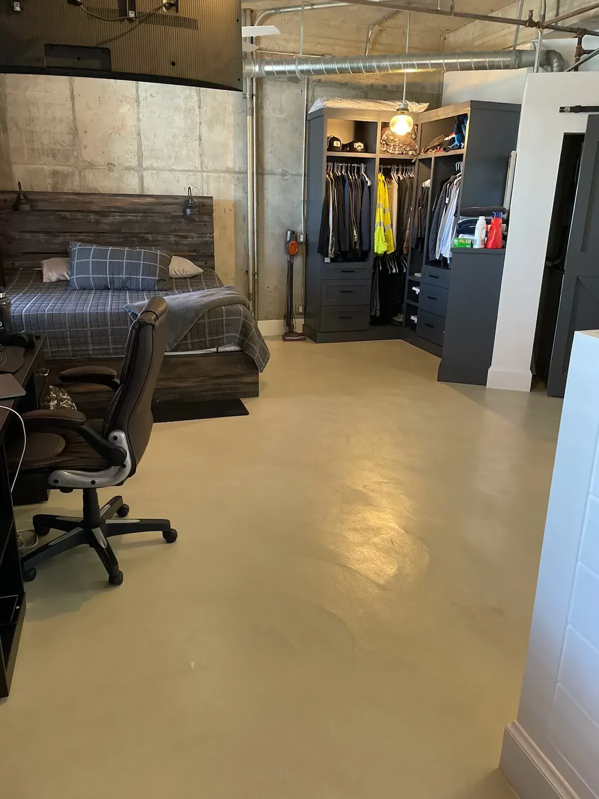 A bedroom with a bed , desk , chair and closet.