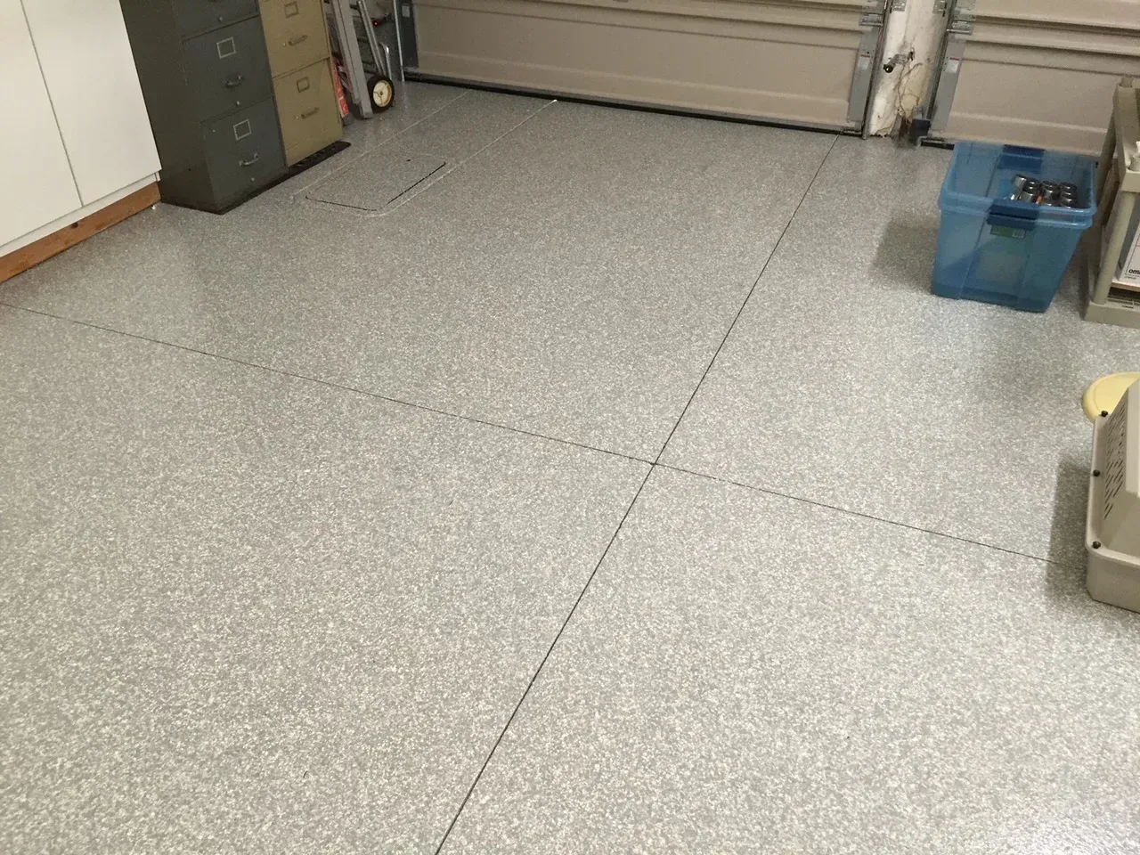 A garage with a concrete floor and a garage door.