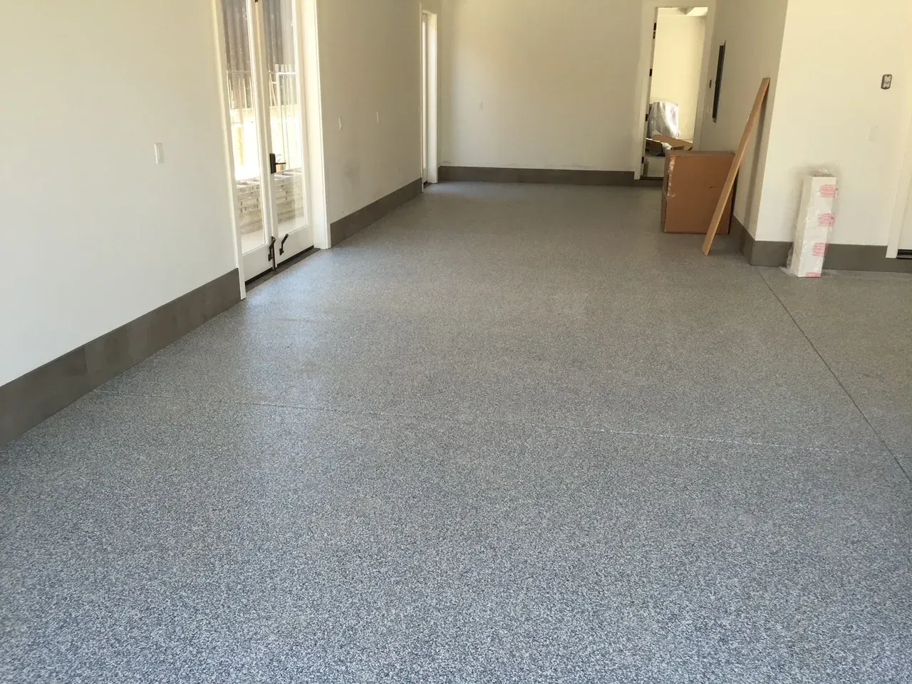 A room with a gray floor and white walls