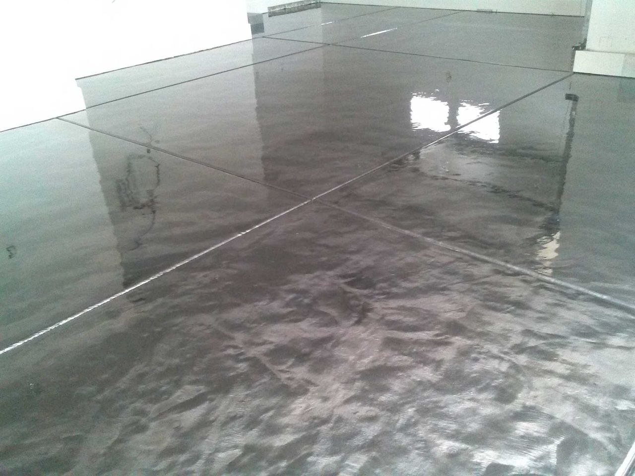 A close up of a shiny metallic floor in a room.